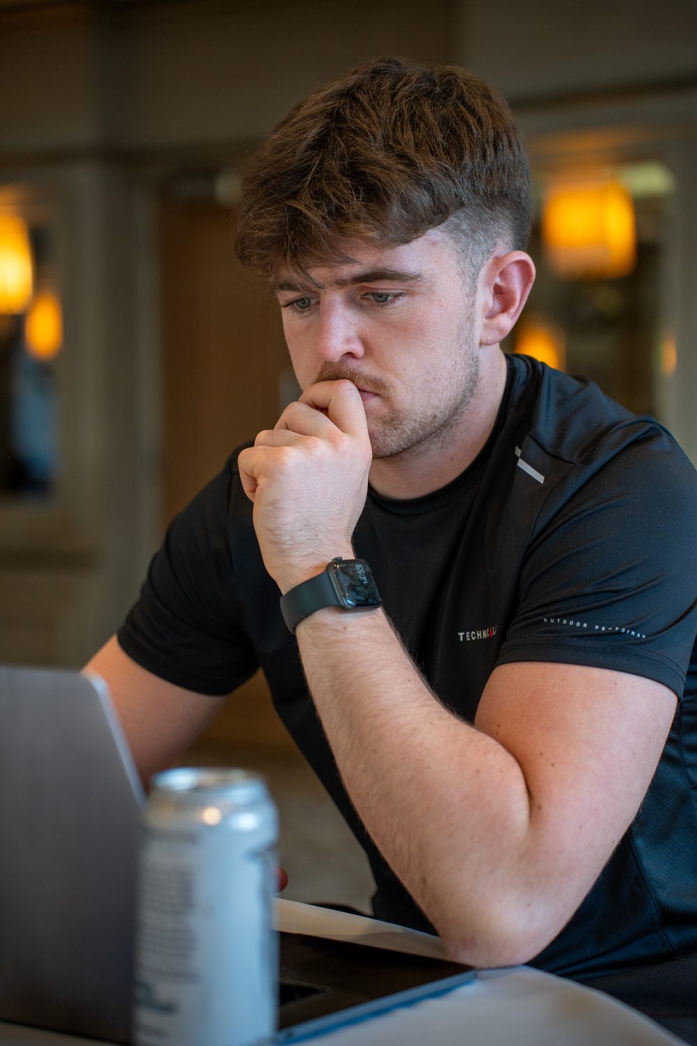 FeganFit coach focused at his laptop